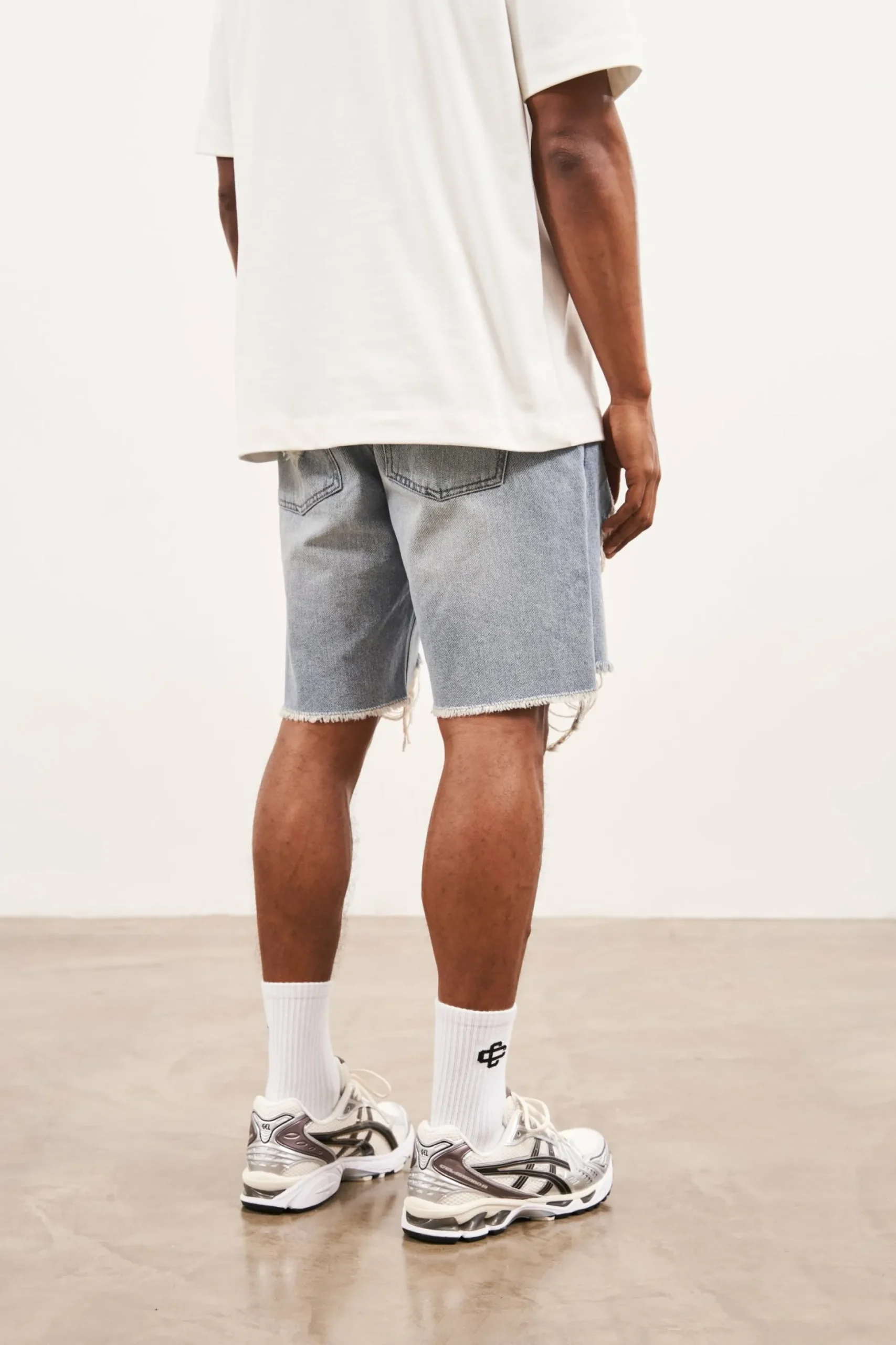 distressed_raw_hem_denim__3-1.webp The Couture Club Distressed Raw Hem Denim Shorts